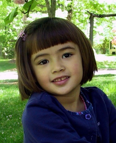 Perfectly poised little Veronica, smiling at camera